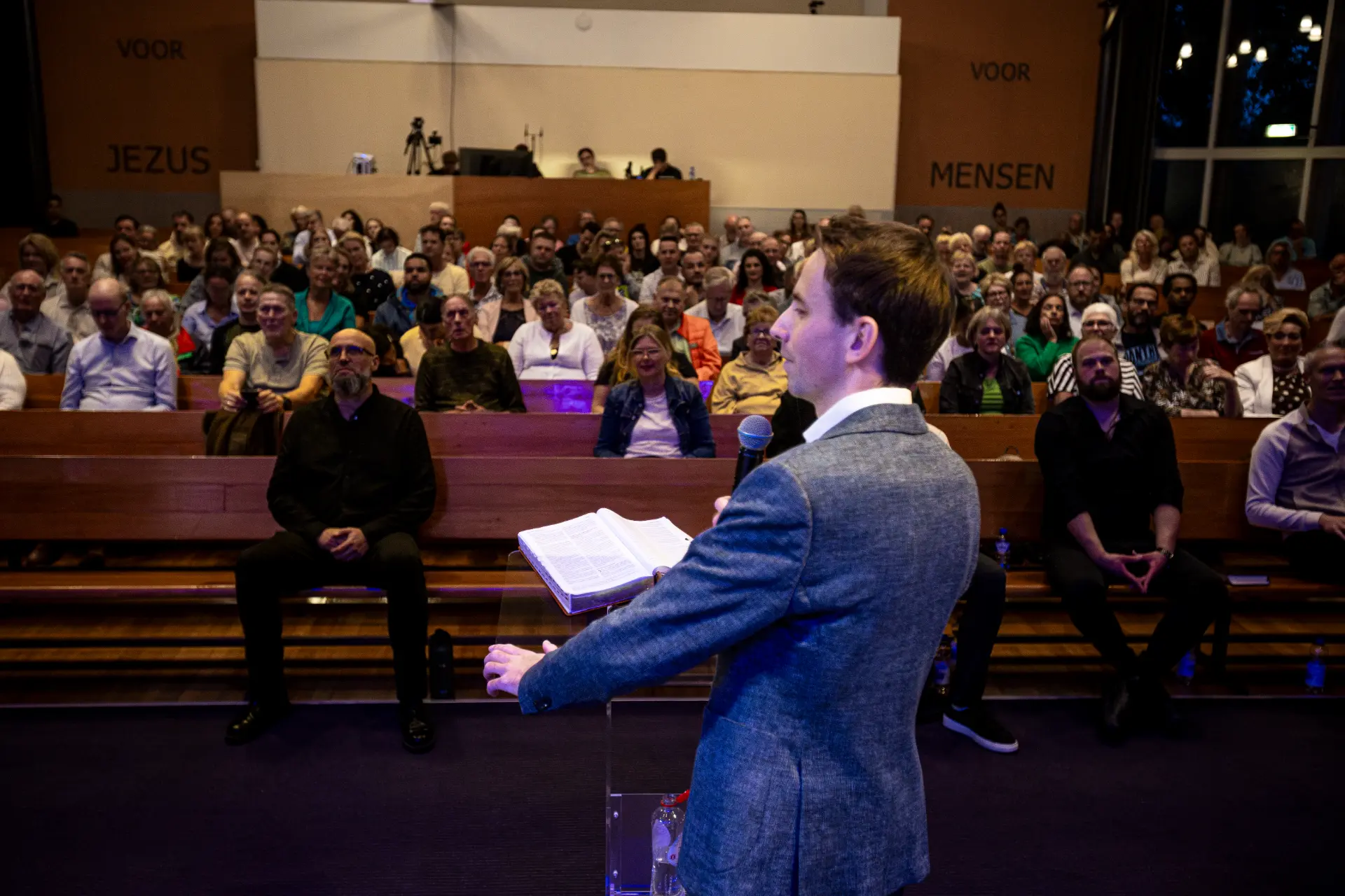 Jelthe Kloens preaching with an open Bible during a Healing Service